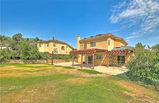 rear view of house featuring a patio, a pergola, stucco siding, a tiled roof, and a lawn