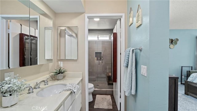 full bathroom with a shower stall, toilet, and vanity