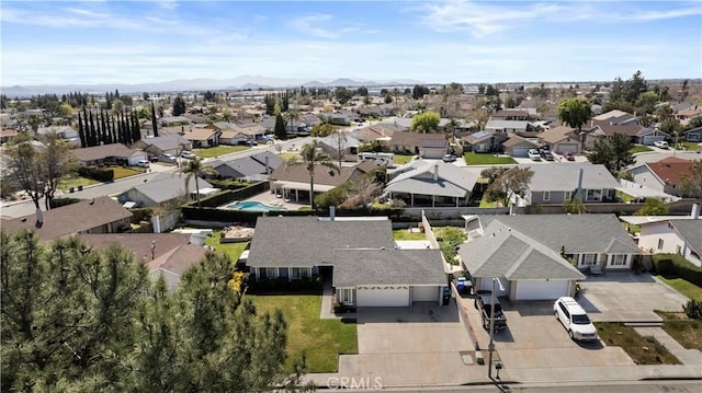 drone / aerial view featuring a residential view and a mountain view