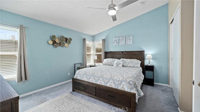 carpeted bedroom with a textured ceiling, baseboards, and vaulted ceiling