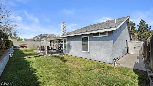 back of property with a storage unit, stucco siding, a pergola, a patio, and a fenced backyard