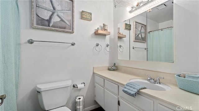 full bath featuring vanity, toilet, and visible vents