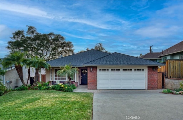 ranch-style home with a front lawn, roof with shingles, concrete driveway, a garage, and brick siding