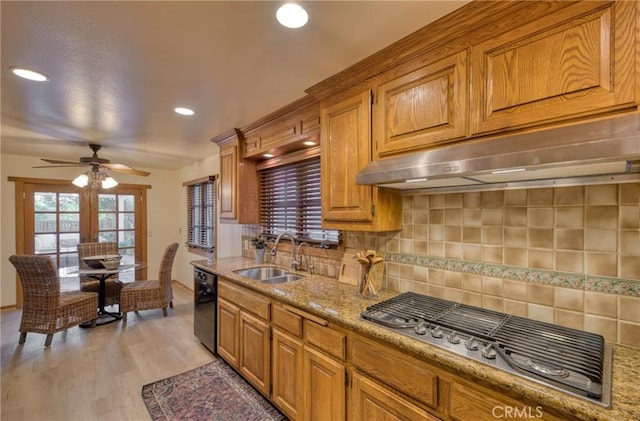 kitchen featuring stainless steel gas cooktop, a sink, decorative backsplash, black dishwasher, and under cabinet range hood