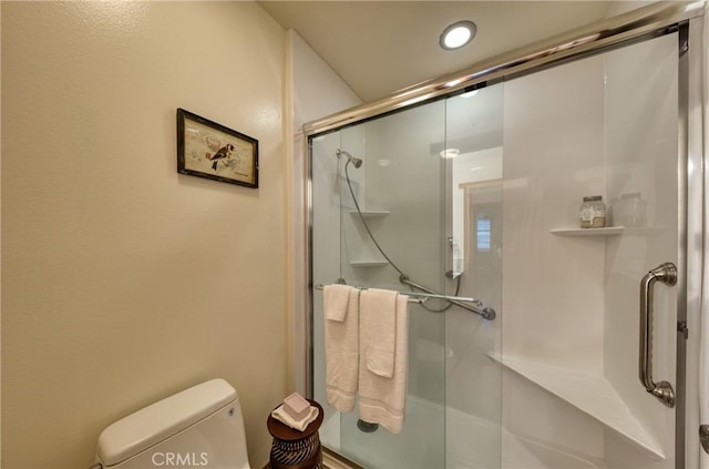 full bathroom with toilet and a shower stall