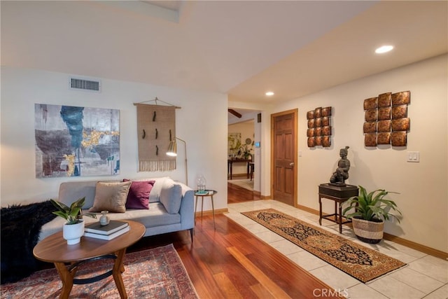 living room with visible vents, recessed lighting, light wood-type flooring, and baseboards