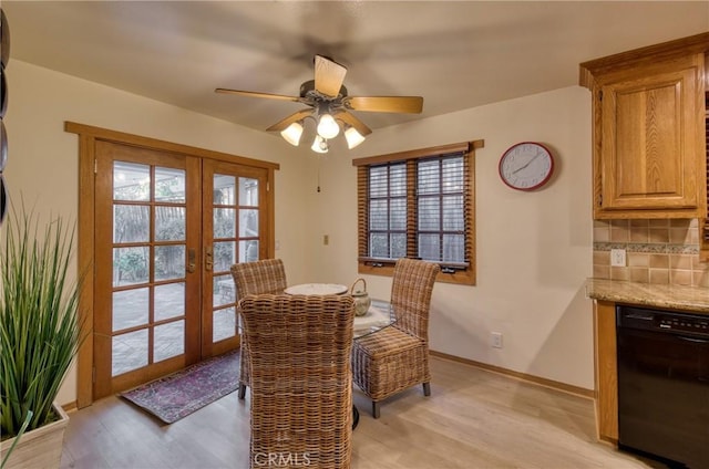 dining area featuring french doors, baseboards, light wood finished floors, and ceiling fan