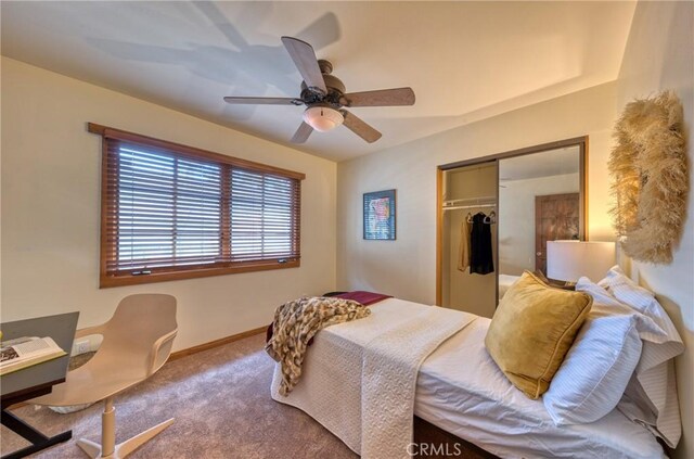 bedroom featuring a closet, carpet flooring, a ceiling fan, and baseboards