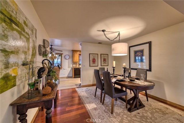 dining space featuring visible vents, baseboards, and wood finished floors