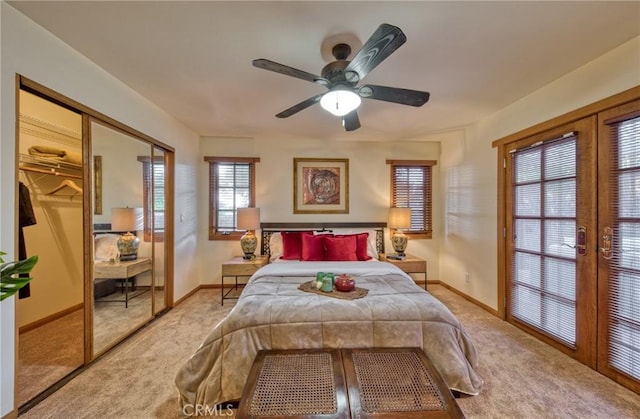 carpeted bedroom featuring french doors, baseboards, a closet, and ceiling fan