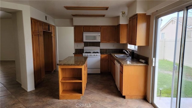 kitchen featuring brown cabinets, a sink, open shelves, a kitchen island, and white appliances