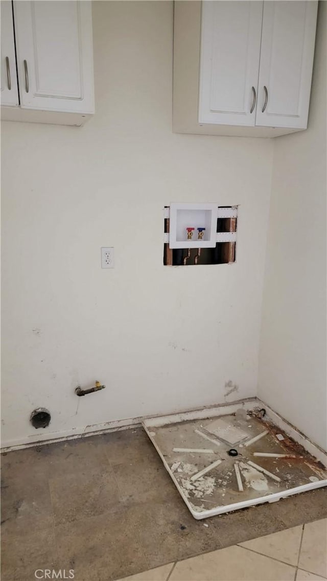 washroom with washer hookup and cabinet space