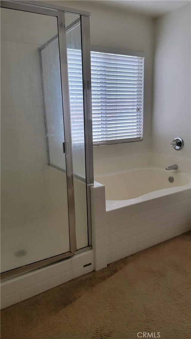 bathroom featuring a shower stall, speckled floor, carpet, and a garden tub