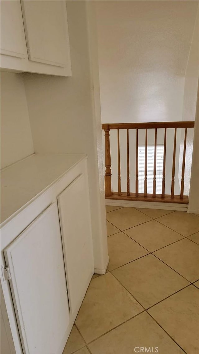 hallway featuring light tile patterned flooring