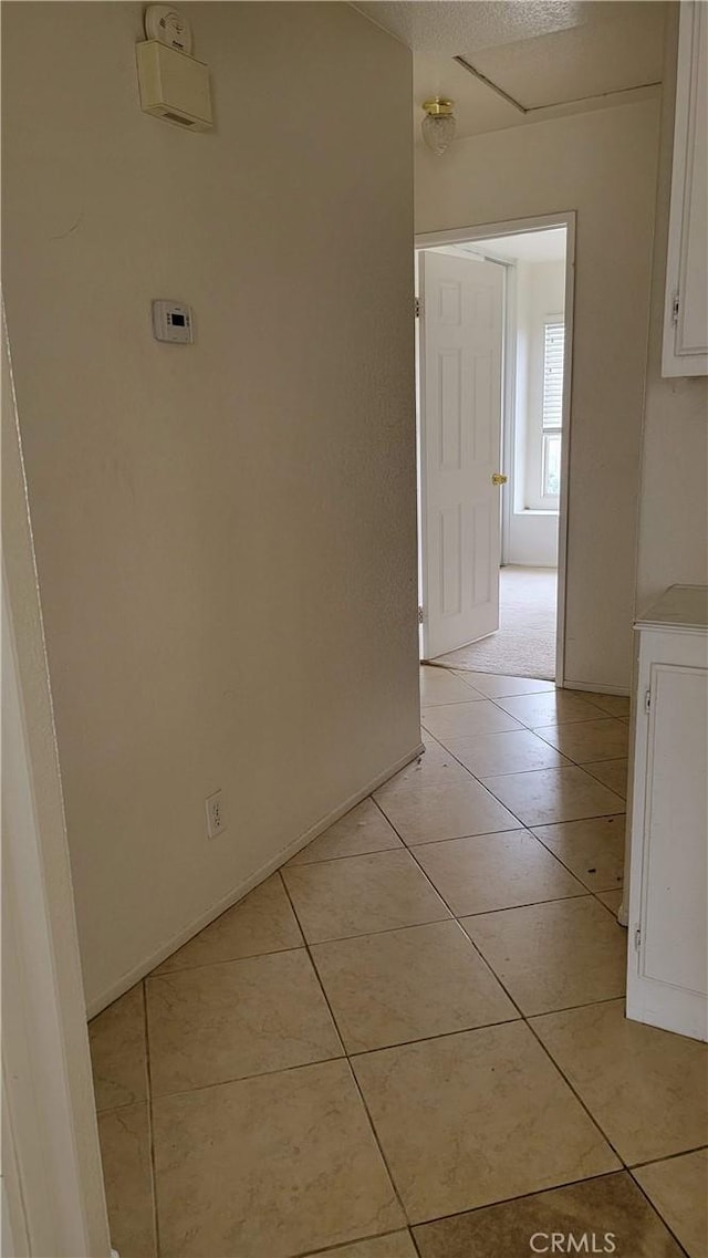 hallway featuring light tile patterned flooring