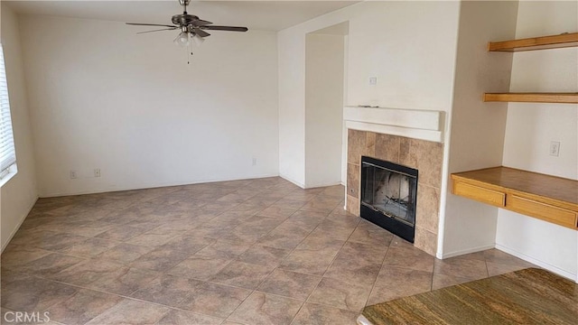 unfurnished living room featuring a fireplace and a ceiling fan