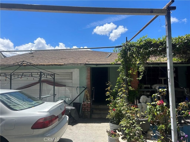 exterior space with a shingled roof