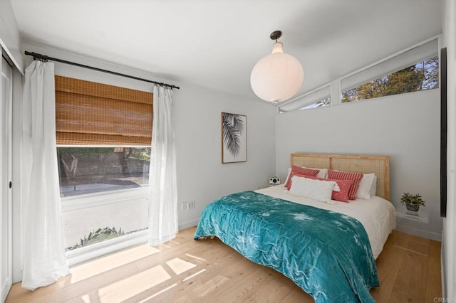 bedroom featuring wood finished floors and baseboards