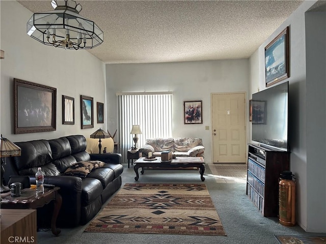 carpeted living area featuring a notable chandelier and a textured ceiling