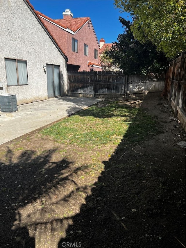 view of yard with a patio area and a fenced backyard