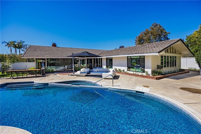 view of pool featuring a fenced in pool, fence, outdoor lounge area, and a patio area