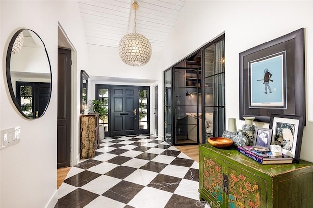 foyer featuring lofted ceiling and tile patterned floors