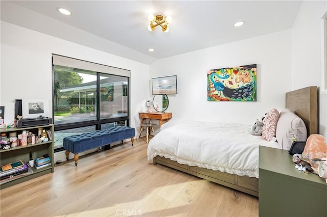 bedroom with vaulted ceiling, access to outside, recessed lighting, and wood finished floors