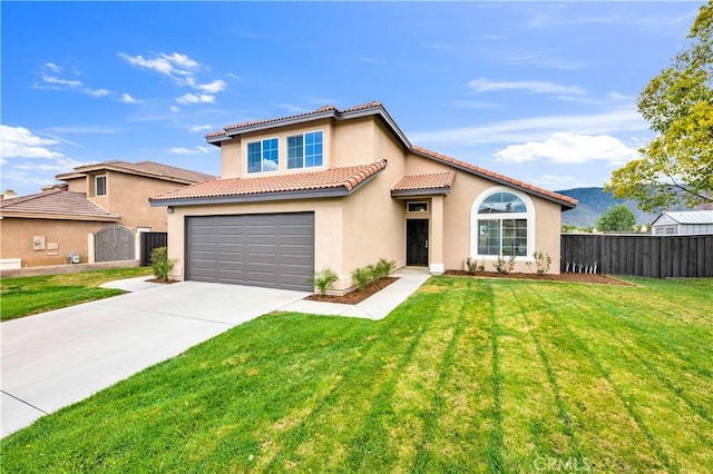 mediterranean / spanish house featuring a front yard, fence, driveway, an attached garage, and stucco siding