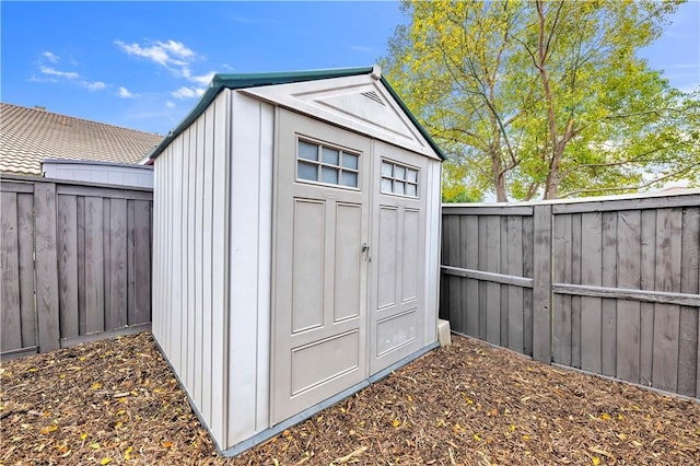 view of shed with a fenced backyard