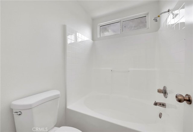 bathroom with tub / shower combination and toilet