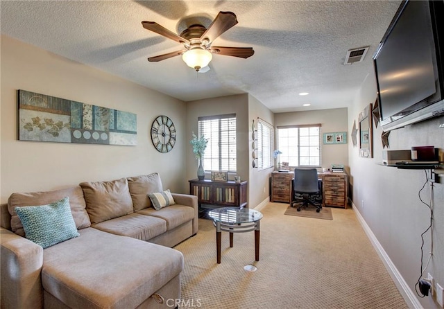 living room with light carpet, visible vents, a textured ceiling, and baseboards