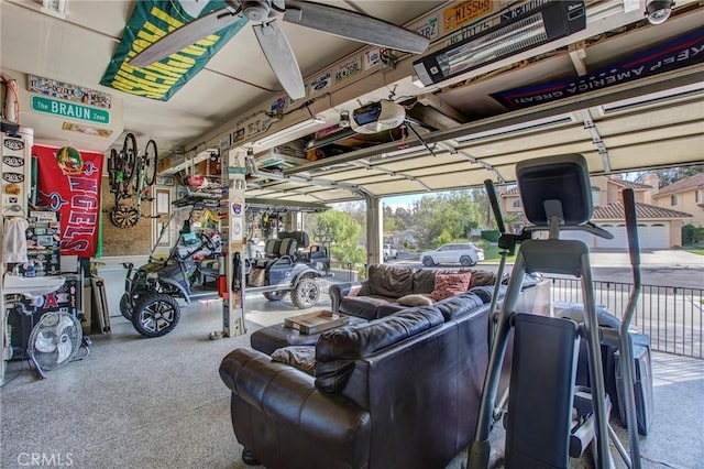 garage with a garage door opener and a ceiling fan