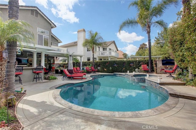 view of swimming pool featuring a pool with connected hot tub and a patio area