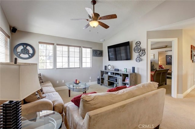 living area with light colored carpet, baseboards, ceiling fan, and vaulted ceiling