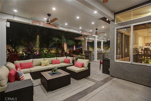 patio at night featuring an outdoor hangout area and ceiling fan