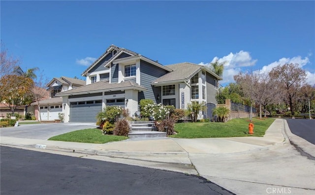 view of front of home with a garage, a front yard, and driveway