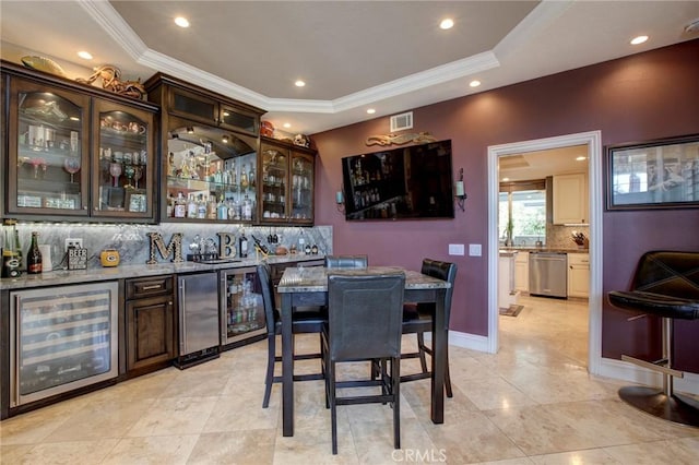 bar with dishwasher, a dry bar, beverage cooler, and backsplash