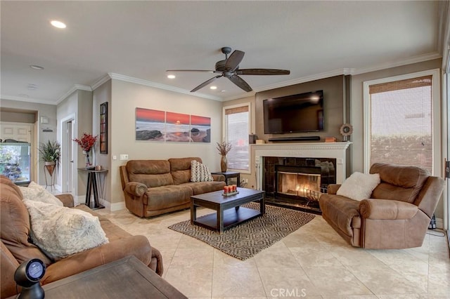 living room featuring recessed lighting, a premium fireplace, baseboards, and crown molding