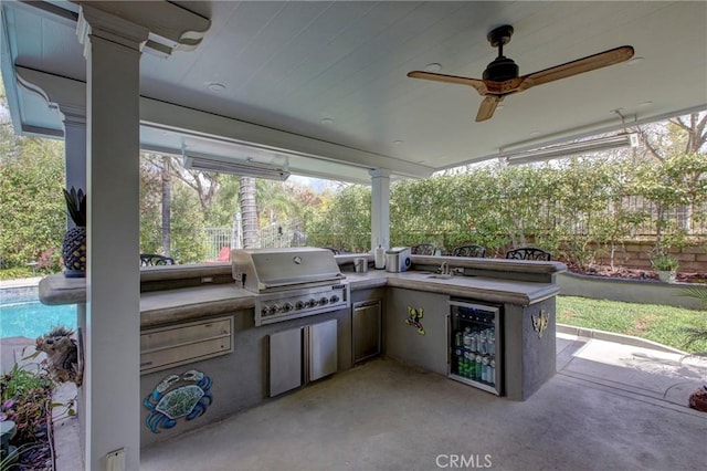 view of patio featuring grilling area, exterior kitchen, a ceiling fan, and fence