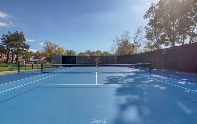 view of tennis court featuring fence