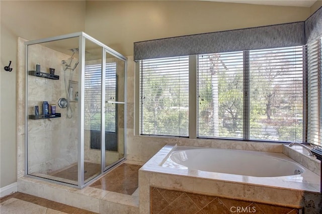 bathroom with a garden tub and a stall shower