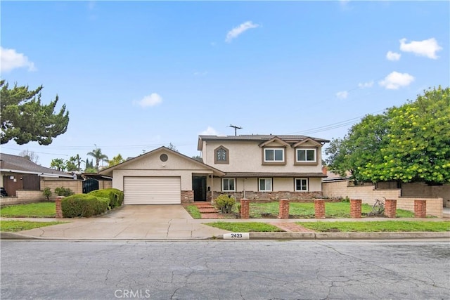 traditional home featuring stucco siding, concrete driveway, an attached garage, and fence