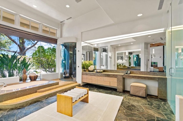 full bath featuring recessed lighting, marble finish floor, a bath, and vanity