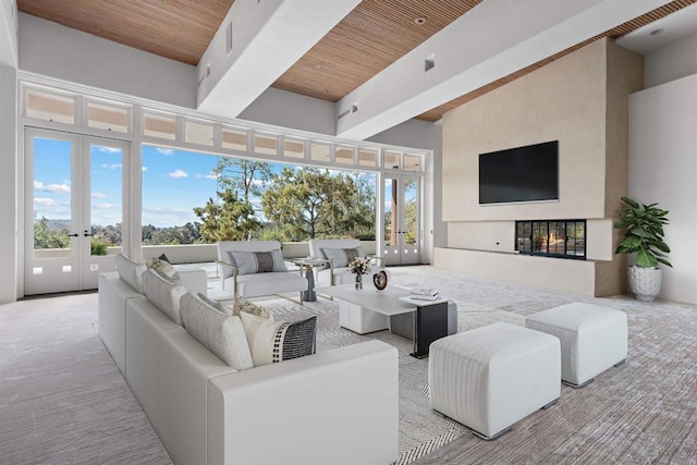 carpeted living area featuring a multi sided fireplace, french doors, wooden ceiling, and a high ceiling