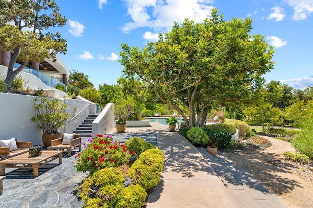 view of patio featuring an outdoor pool and stairs