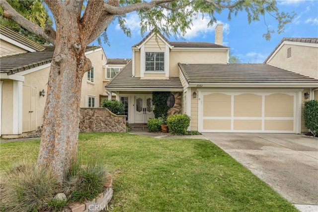 traditional-style house with a front lawn, a tile roof, concrete driveway, a chimney, and an attached garage