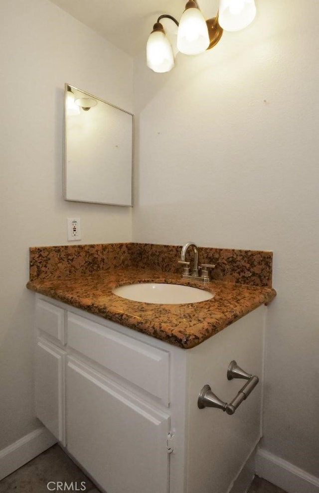 bathroom with baseboards and vanity