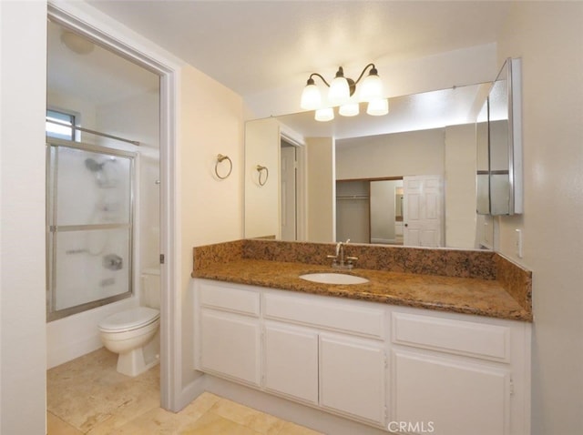 full bathroom featuring vanity, toilet, tile patterned flooring, and shower / bath combination with glass door