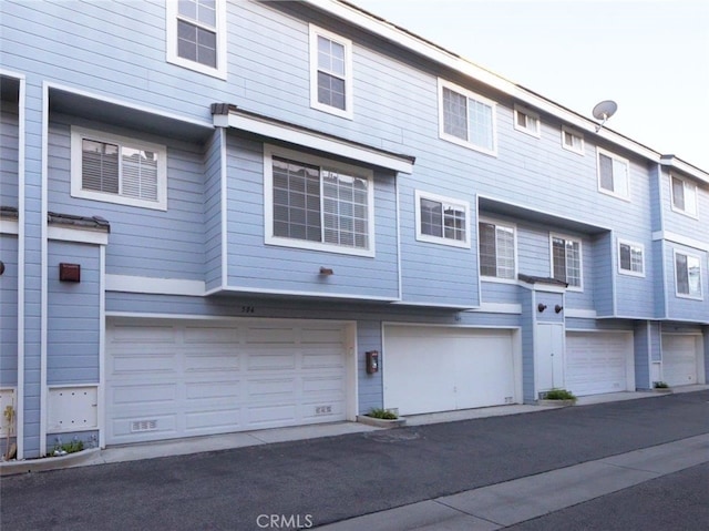 rear view of house with a garage