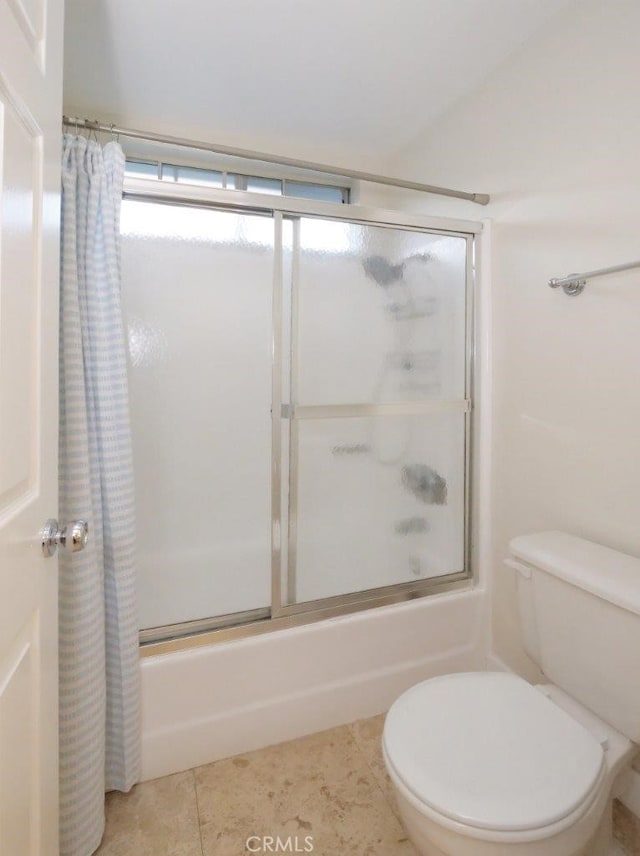 full bath with tile patterned floors, bath / shower combo with glass door, and toilet